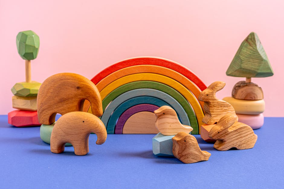 A vibrant still life of wooden animal toys and a rainbow on a colorful background.